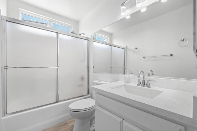 37116 Alder St, Palmdale, CA 93552 - full bath featuring toilet, vanity, bath / shower combo with glass door, and wood finished floors