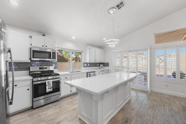 37116 Alder St, Palmdale, CA 93552 - kitchen with stainless steel appliances, a sink, light countertops, decorative backsplash, and white cabinets
