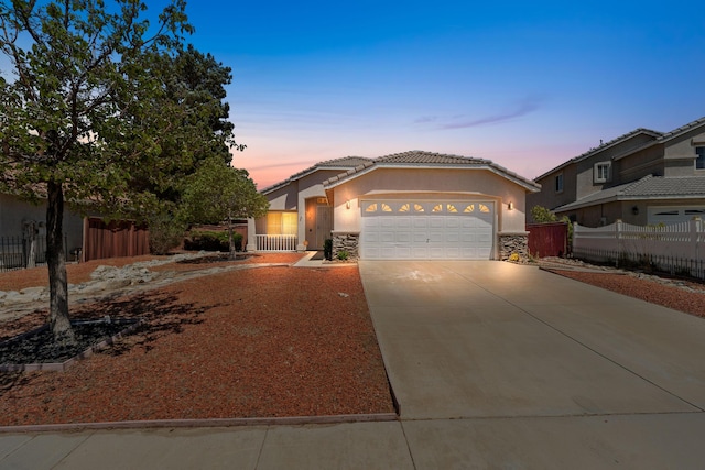 37116 Alder St, Palmdale, CA 93552 - view of front of home featuring stone siding, a garage, driveway, stucco siding, and a tiled roof