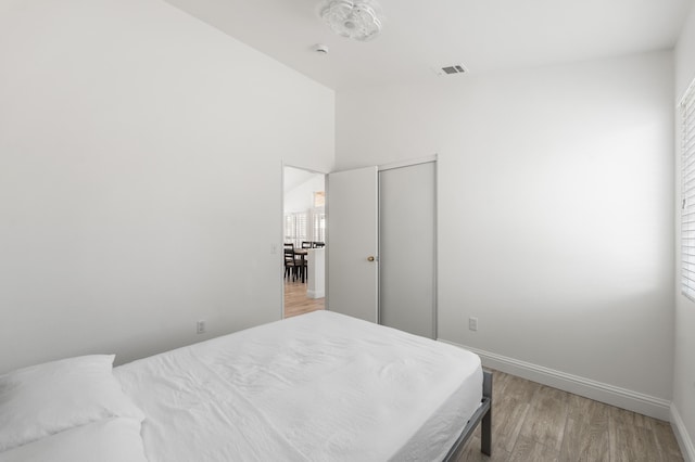 37116 Alder St, Palmdale, CA 93552 - bedroom featuring light wood-style floors, baseboards, vaulted ceiling, and a closet