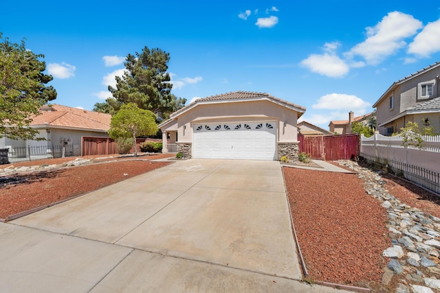 37116 Alder St, Palmdale, CA 93552 - ranch-style home featuring stone siding, concrete driveway, a tiled roof, stucco siding, and a garage