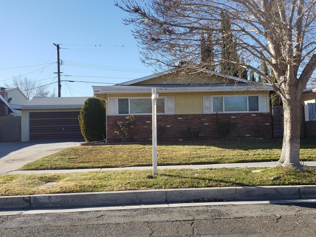 view of front of house featuring a garage and a front lawn