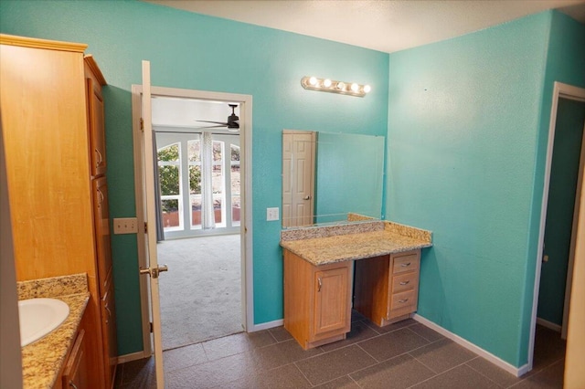 bathroom featuring ceiling fan and vanity