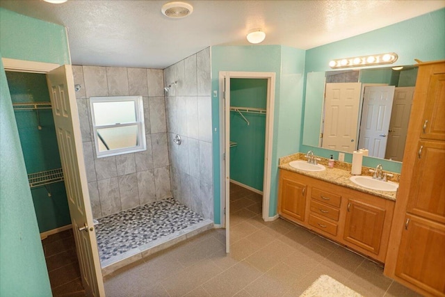 bathroom featuring vanity and a tile shower