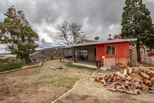 40005 W 92nd St Unit W, Leona Valley, CA 93551 - back of house featuring a fire pit and a patio area
