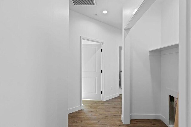 corridor with dark hardwood / wood-style floors