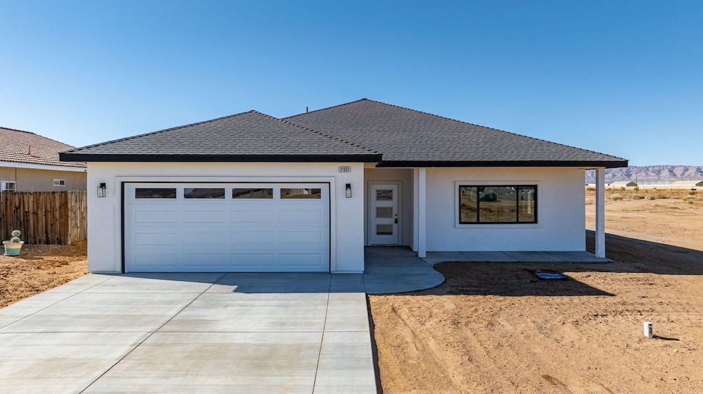 view of front of property featuring a garage and a mountain view