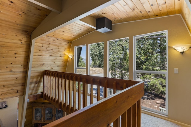 interior space with a wealth of natural light, carpet floors, and vaulted ceiling with beams