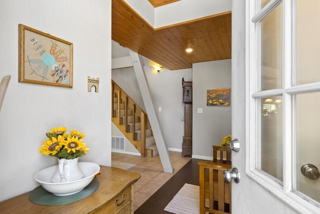 tiled entryway featuring wood ceiling