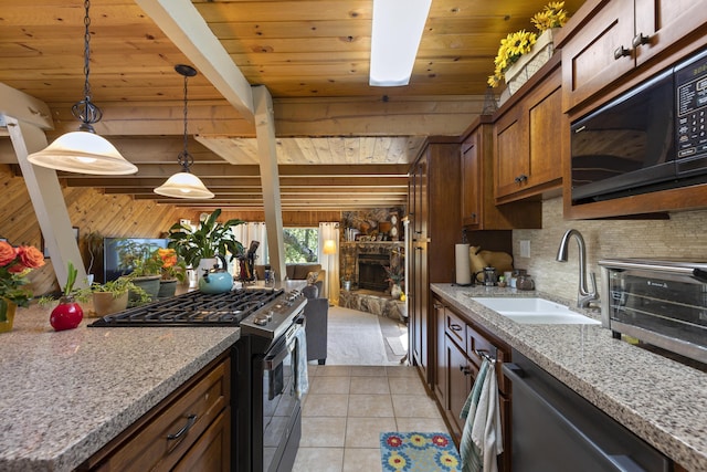 kitchen featuring appliances with stainless steel finishes, decorative light fixtures, sink, light tile patterned floors, and wooden ceiling