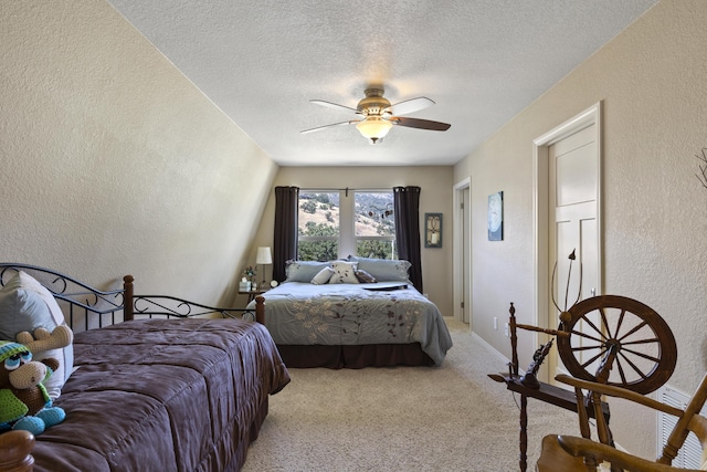 carpeted bedroom featuring ceiling fan and a textured ceiling