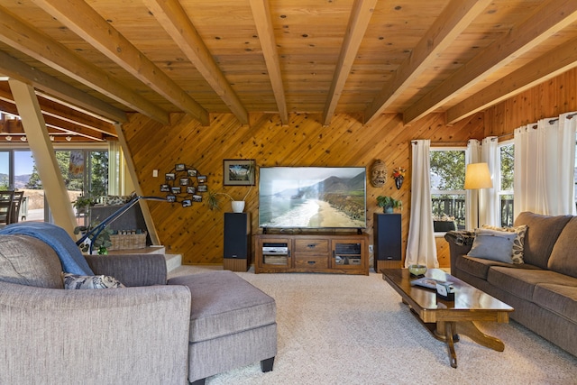 living room featuring lofted ceiling with beams, carpet floors, wooden ceiling, and wooden walls