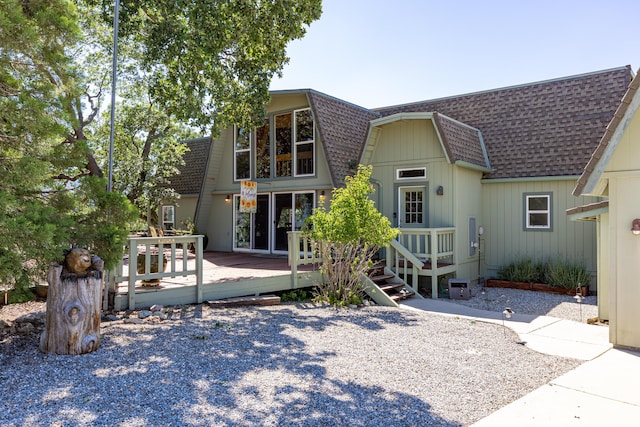 rear view of house featuring a deck