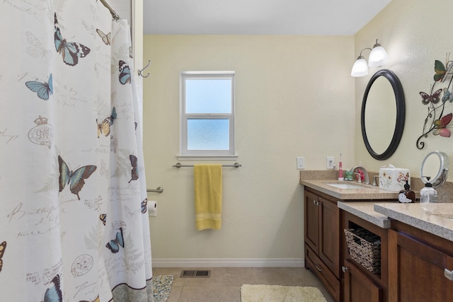 bathroom with tile patterned floors and vanity