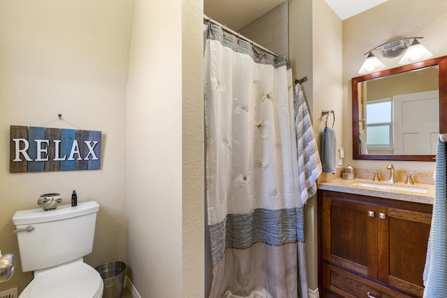 bathroom featuring vanity, toilet, and a shower with shower curtain