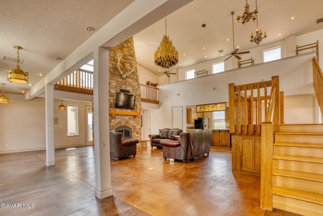 9250 Elizabeth Lake Rd, Leona Valley, CA 93551 - living room with stairway, a stone fireplace, a towering ceiling, ceiling fan, and recessed lighting
