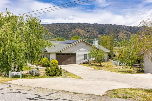 23600 Dart Dr, Tehachapi, CA 93561 - single story home featuring a chimney, concrete driveway, a garage, and a mountain view