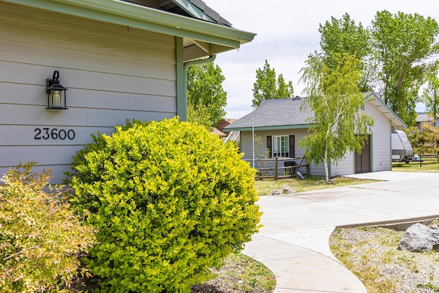 23600 Dart Dr, Tehachapi, CA 93561 - view of home's exterior with concrete driveway, a shingled roof, and a garage