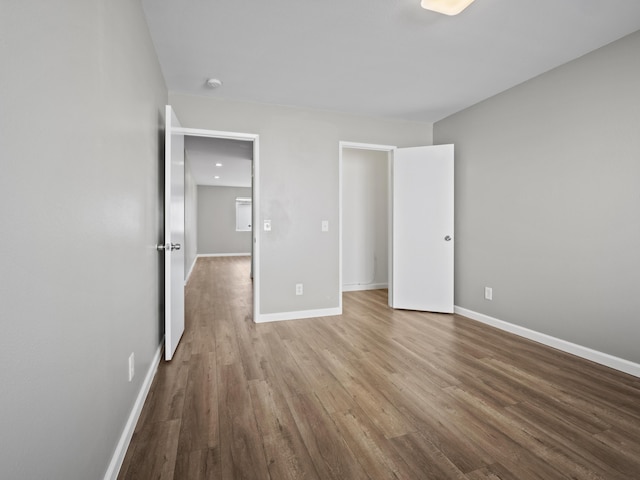 unfurnished bedroom with baseboards and wood finished floors