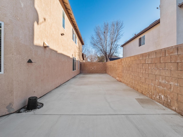 view of home's exterior with a patio area, a fenced backyard, and stucco siding