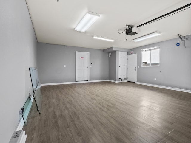 garage with baseboards and a garage door opener