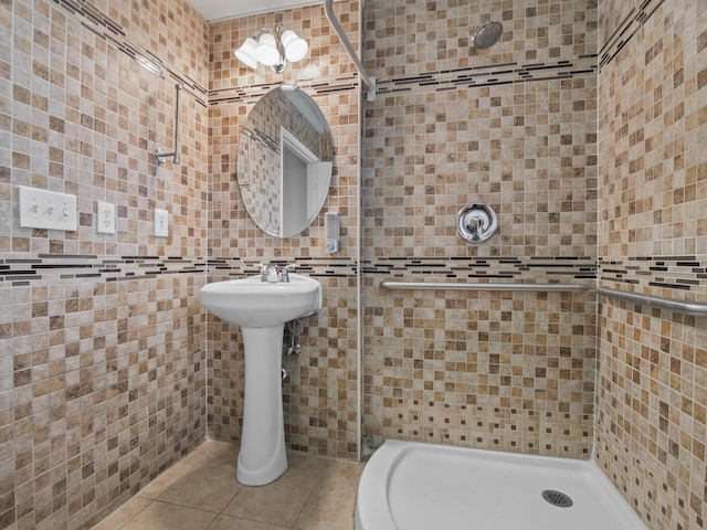 full bath with a shower stall, tile walls, and tile patterned floors