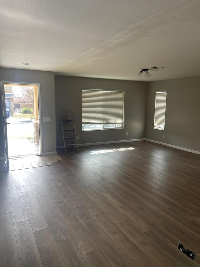 spare room featuring dark hardwood / wood-style flooring