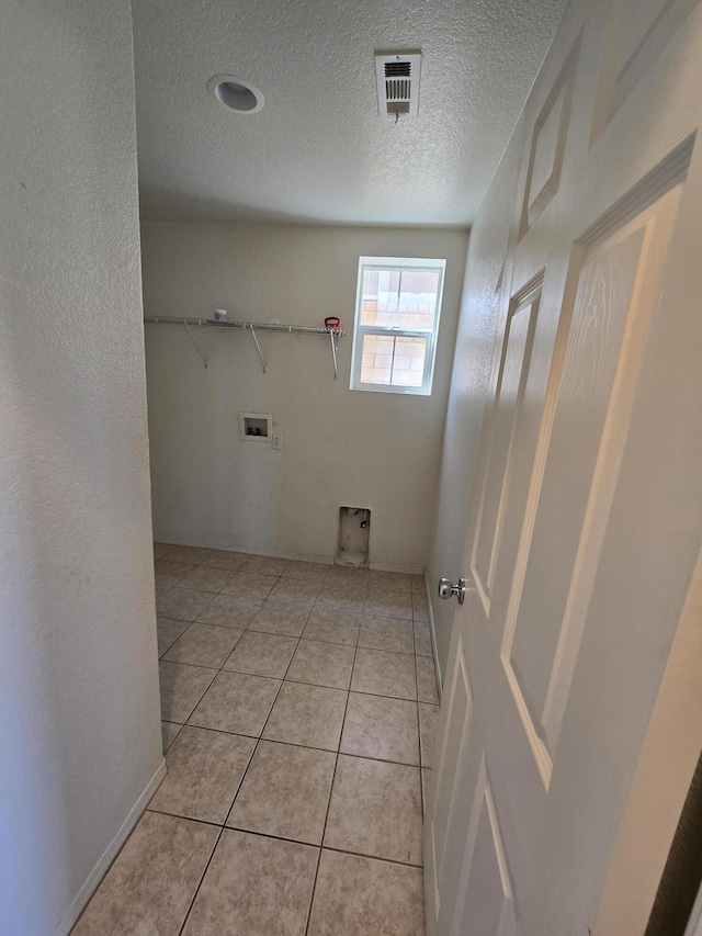 37515 Ruby Red Ln, Palmdale, CA 93551 - laundry area featuring washer hookup, a textured ceiling, and light tile patterned floors