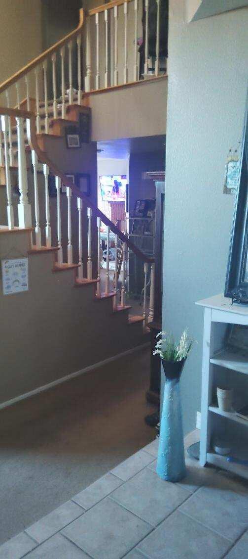 staircase featuring tile patterned flooring