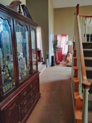 interior space featuring light colored carpet and stairway