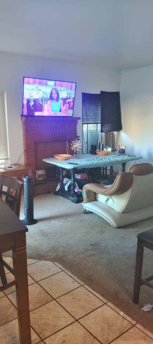 living area featuring carpet and tile patterned flooring