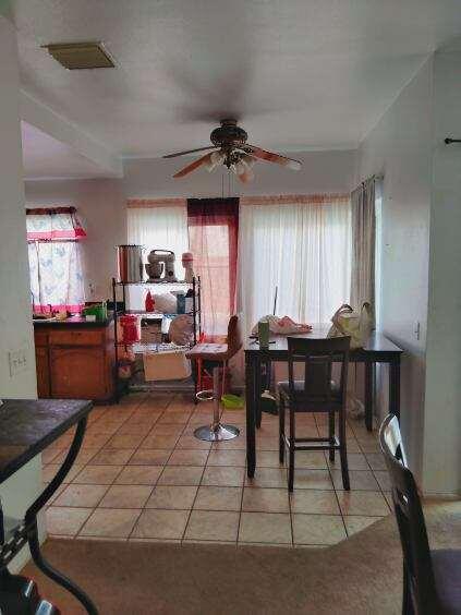 dining area with light tile patterned floors, ceiling fan, and visible vents