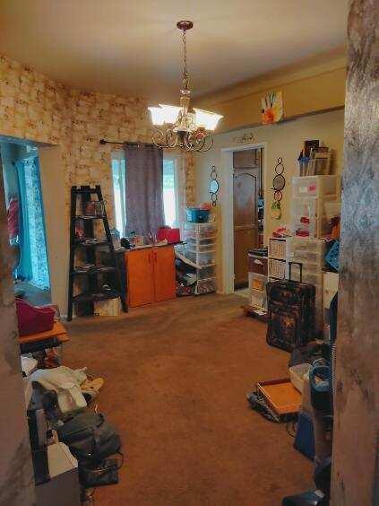 interior space featuring carpet floors and a notable chandelier