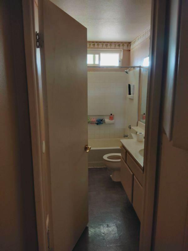 full bathroom with tiled shower / bath combo, vanity, and toilet