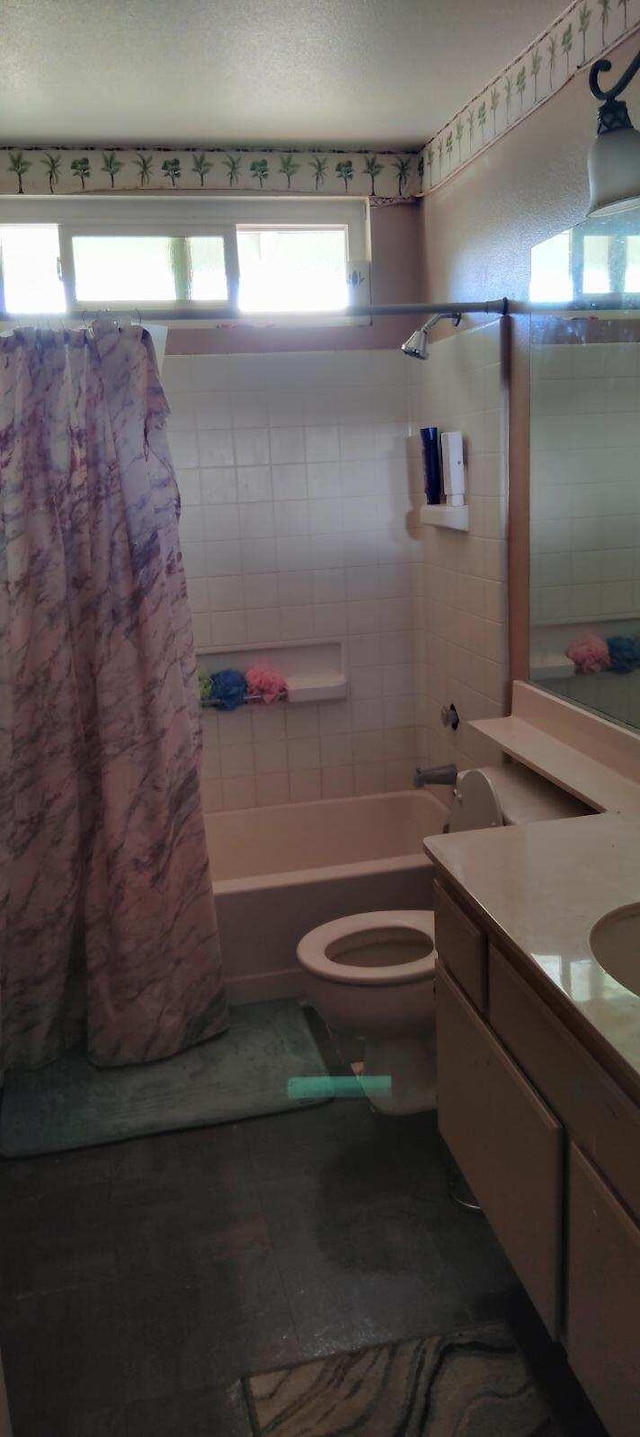 full bathroom featuring vanity, toilet, and shower / bath combo with shower curtain