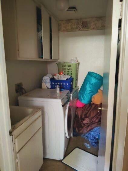 clothes washing area with cabinet space and independent washer and dryer