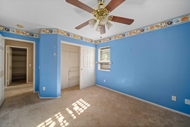 unfurnished bedroom featuring ceiling fan, a closet, carpet, and baseboards