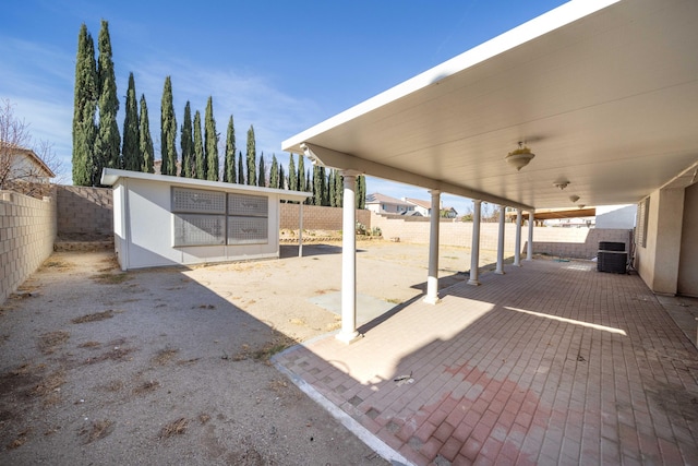 view of patio featuring an outdoor structure and a fenced backyard