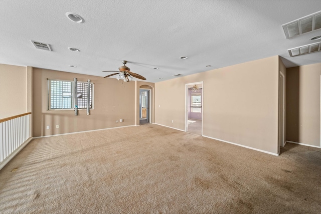 unfurnished room featuring visible vents, ceiling fan, and carpet flooring