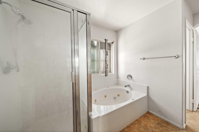 bathroom with a shower stall, a whirlpool tub, and tile patterned floors