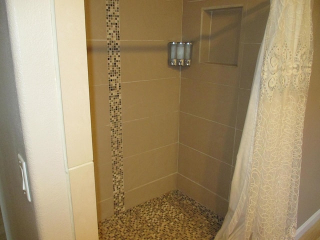 full bath with a tile shower