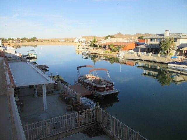 dock area featuring a water view and a residential view