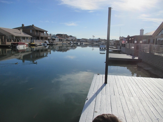 dock area with a water view and a residential view