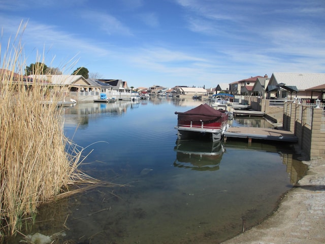 view of dock with a water view and a residential view