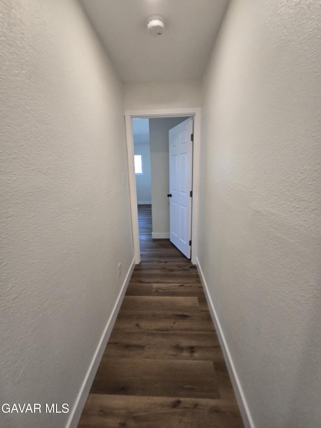 4102 Pearblossom Hwy, Palmdale, CA 93552 - hallway with dark wood-style floors and a textured wall