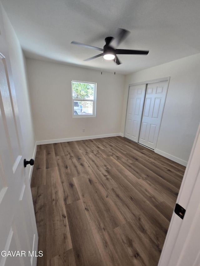 4102 Pearblossom Hwy, Palmdale, CA 93552 - unfurnished bedroom featuring wood finished floors, a closet, and a ceiling fan