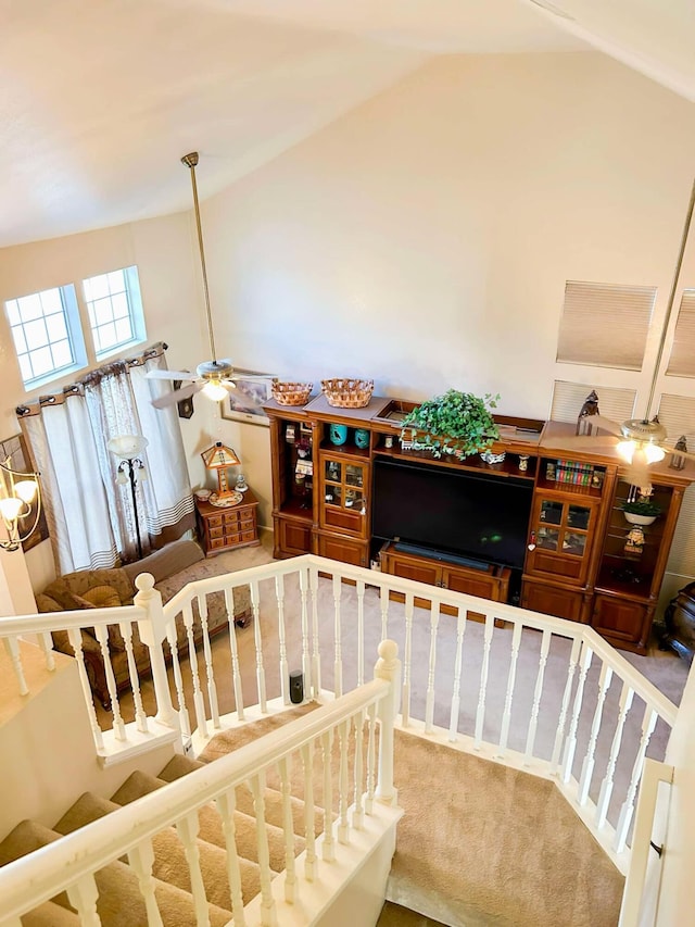 staircase with carpet flooring, vaulted ceiling, and ceiling fan