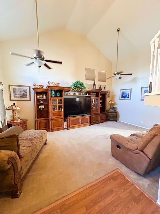 living room with ceiling fan, lofted ceiling, and light hardwood / wood-style flooring