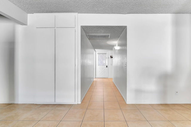 hallway featuring light tile patterned floors