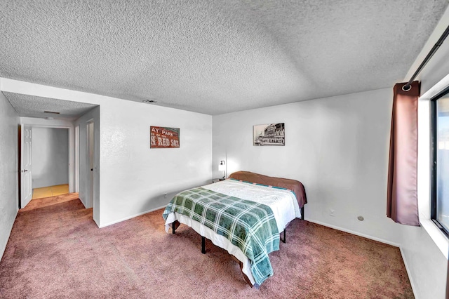 carpeted bedroom featuring a textured ceiling